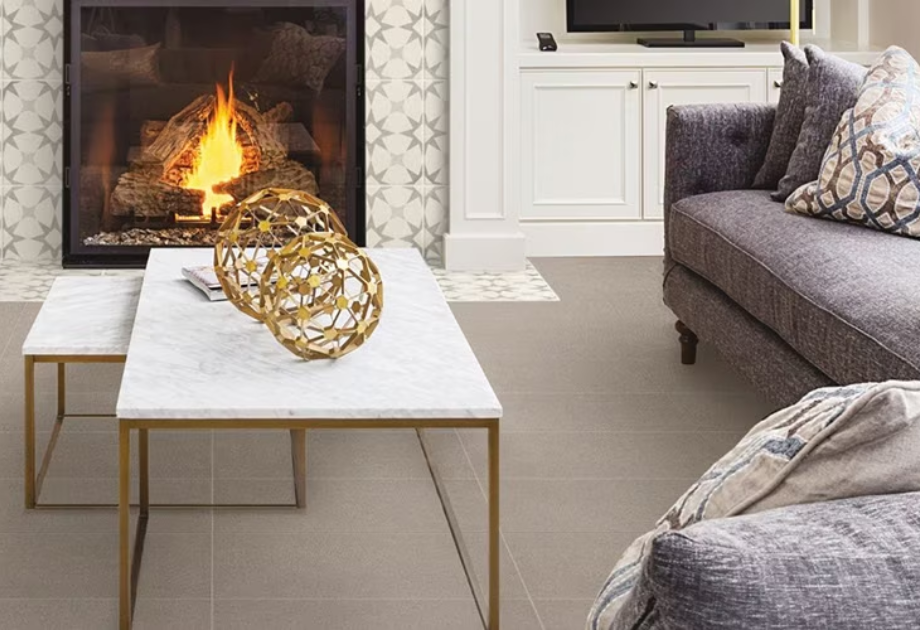 Living space with gray tiles in front of a fireplace and dark gray couch
